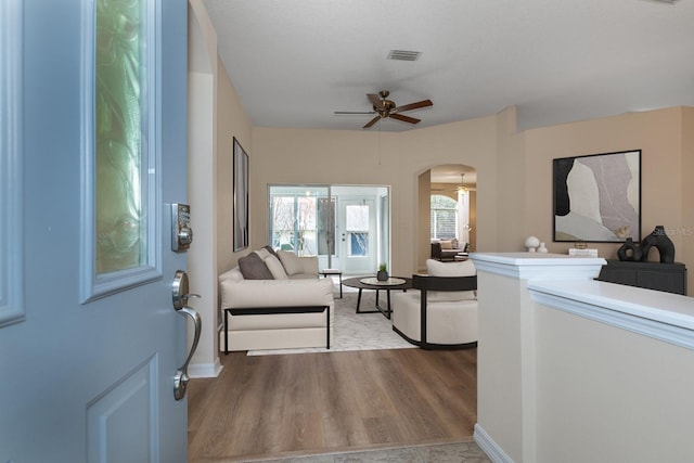 living room featuring ceiling fan and light hardwood / wood-style flooring