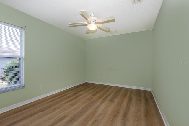 unfurnished room featuring hardwood / wood-style floors, a textured ceiling, and ceiling fan