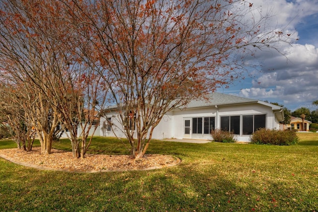 rear view of house with a lawn