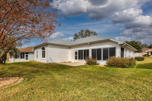 back of house featuring a yard and a patio