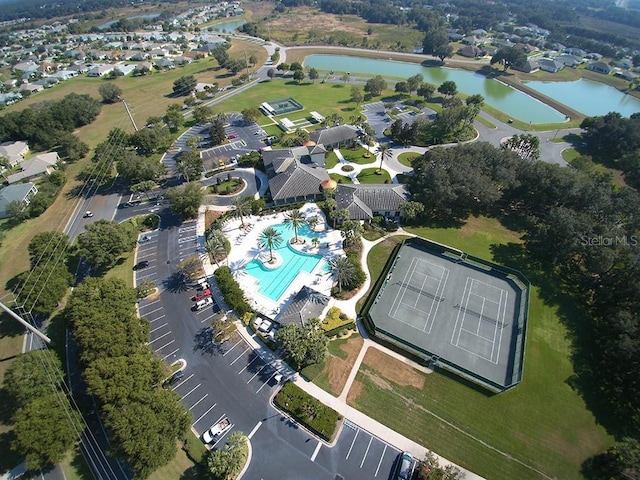 aerial view of property's location with a pool and a large body of water