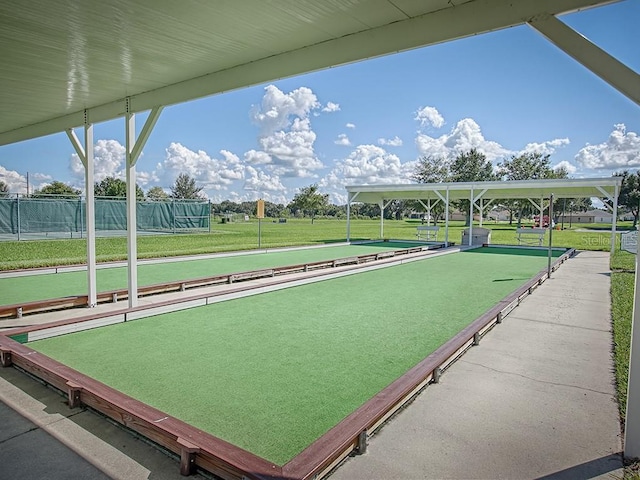 view of property's community with a game area and fence