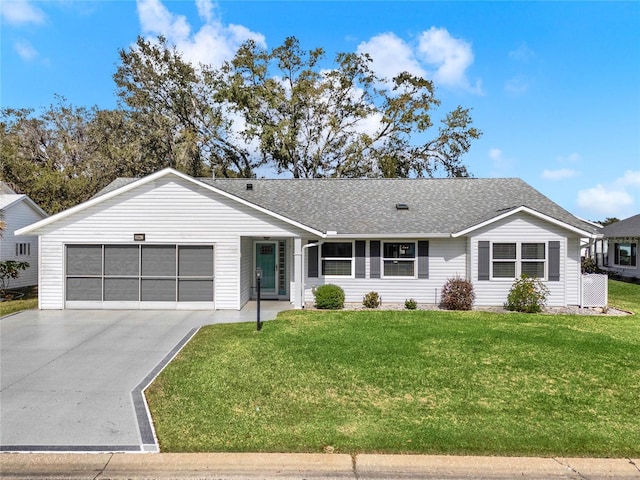 ranch-style house with a garage and a front lawn