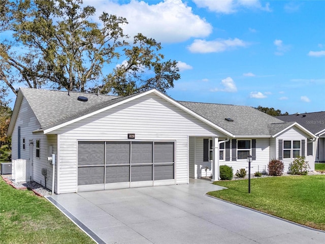 single story home featuring a garage and a front lawn