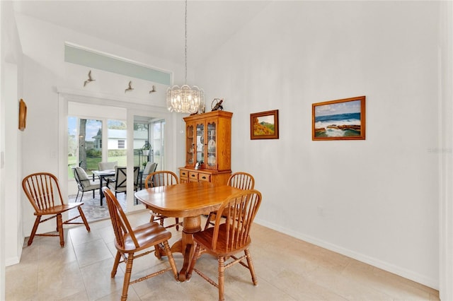 dining area featuring a chandelier, high vaulted ceiling, and light tile patterned floors