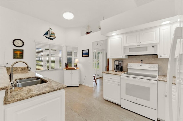 kitchen with sink, white cabinetry, white appliances, light stone countertops, and backsplash