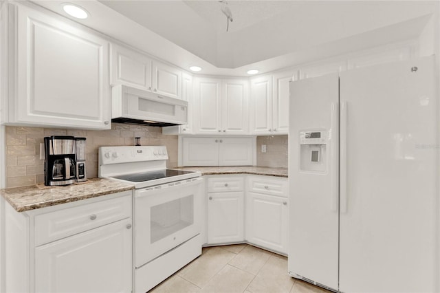 kitchen featuring tasteful backsplash, white cabinetry, light tile patterned floors, light stone countertops, and white appliances