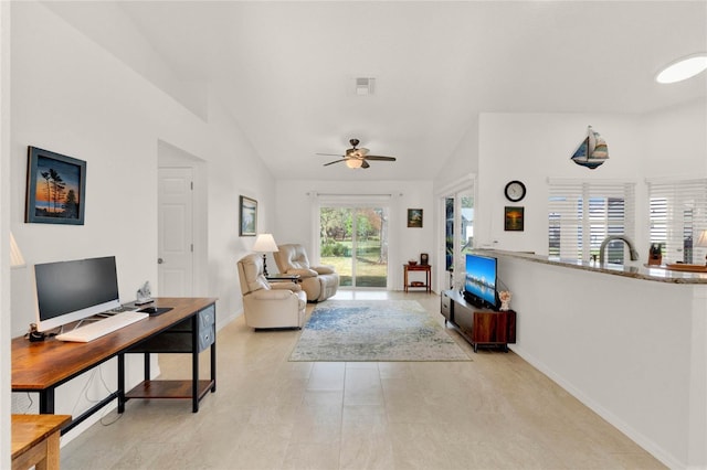 living room with ceiling fan, sink, and vaulted ceiling