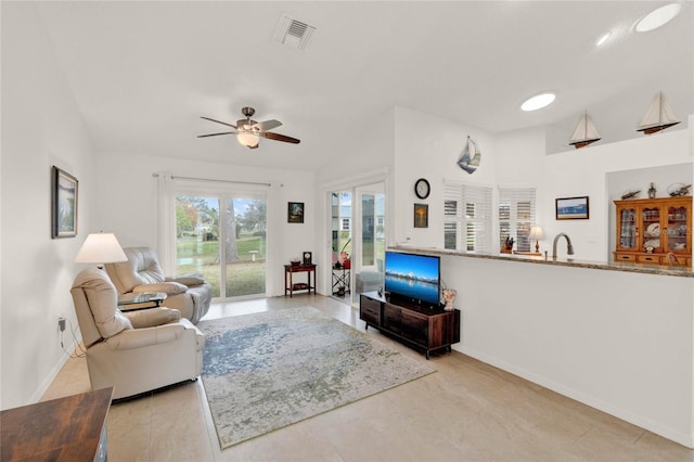 living room with sink and ceiling fan