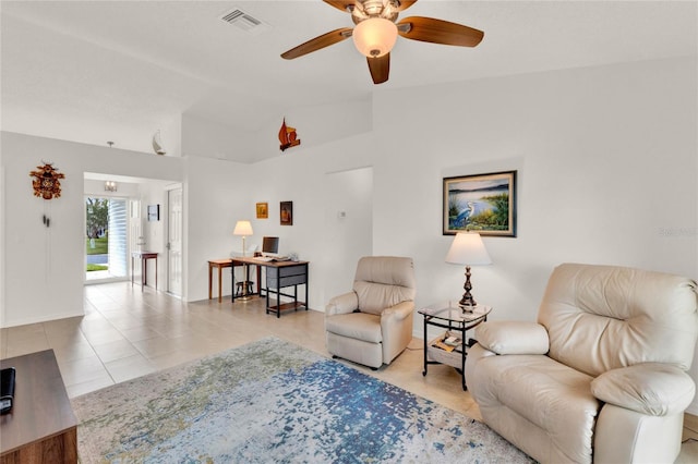 living room with lofted ceiling, light tile patterned floors, and ceiling fan