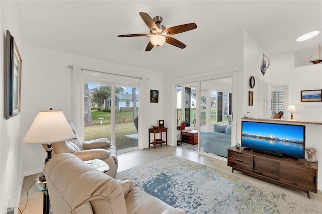 living room with light tile patterned flooring, lofted ceiling, and ceiling fan