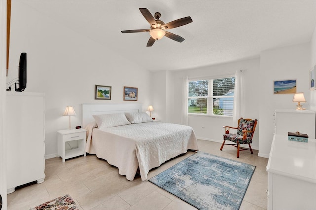 tiled bedroom featuring ceiling fan and vaulted ceiling