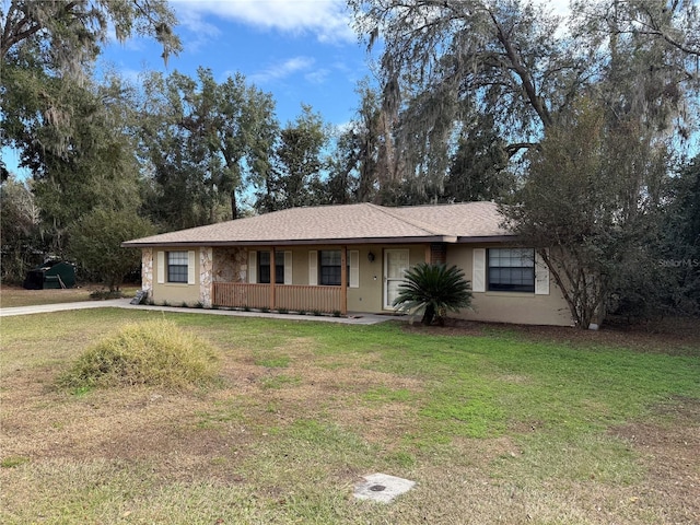 ranch-style house with a front lawn and covered porch