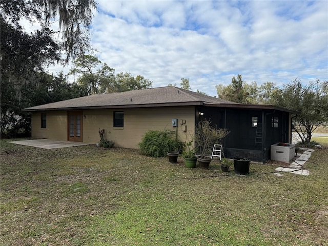 back of house featuring a lawn and a patio