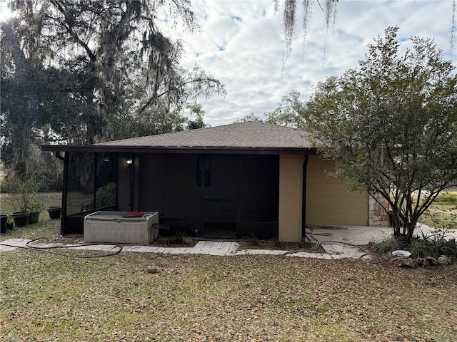 rear view of property featuring a yard