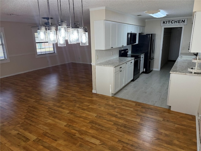 kitchen featuring white cabinetry, ceiling fan, dark hardwood / wood-style flooring, hanging light fixtures, and black appliances