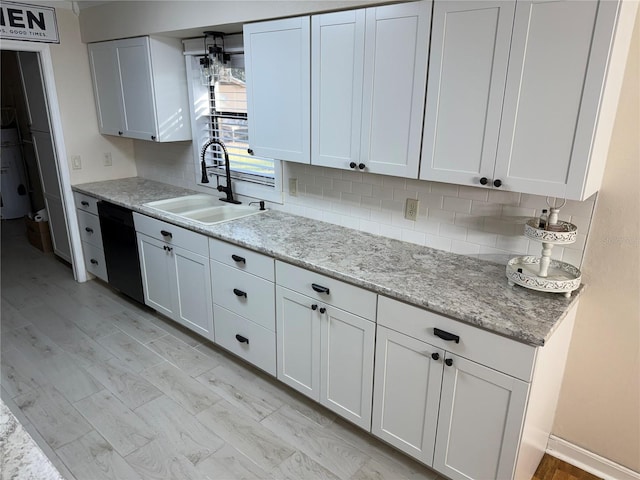 kitchen with white cabinetry, dishwasher, tasteful backsplash, and sink