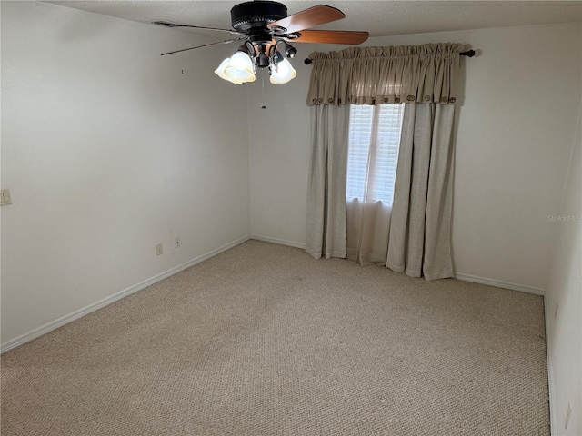 empty room featuring light carpet and ceiling fan