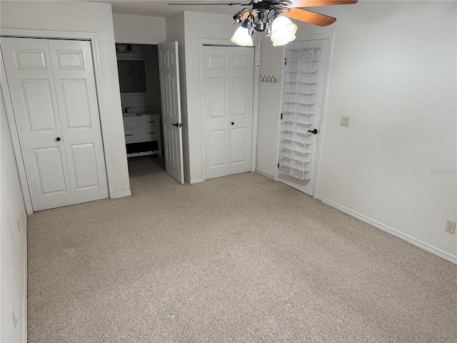 unfurnished bedroom featuring ceiling fan and light colored carpet