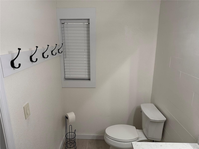 bathroom featuring toilet and hardwood / wood-style flooring