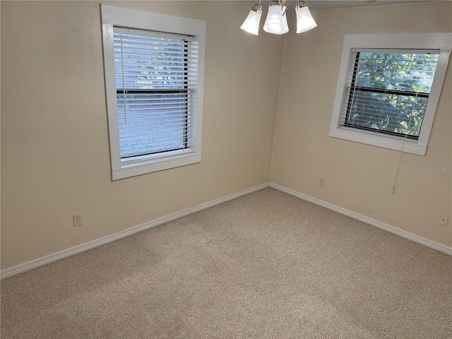 carpeted empty room featuring plenty of natural light