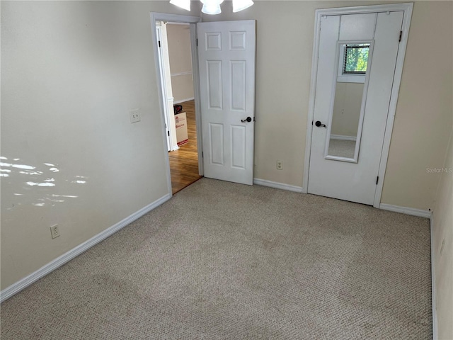 unfurnished bedroom with light colored carpet