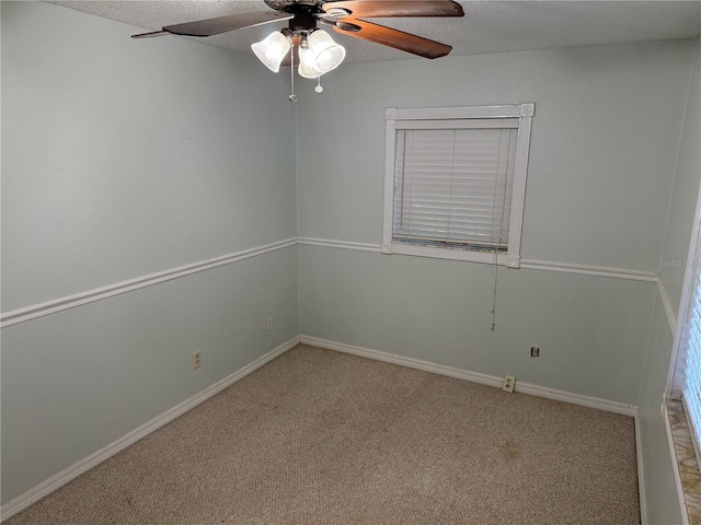 unfurnished room featuring a textured ceiling, ceiling fan, and light colored carpet