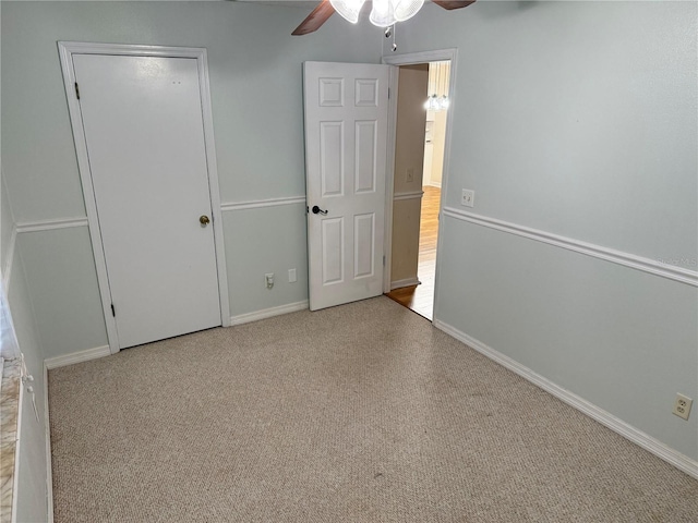 unfurnished bedroom with ceiling fan, a closet, and carpet flooring