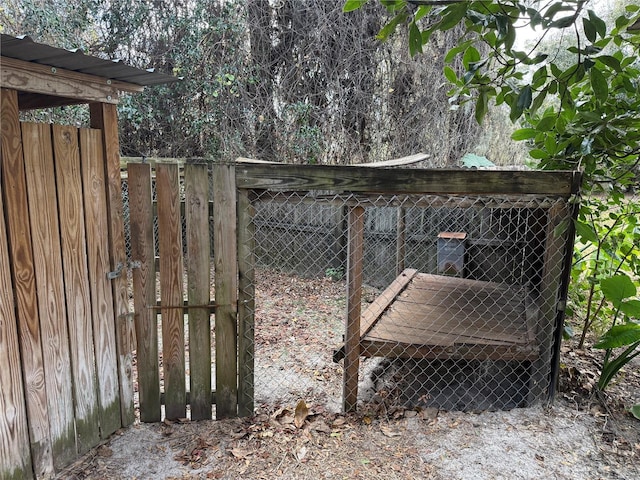 view of gate featuring an outdoor structure