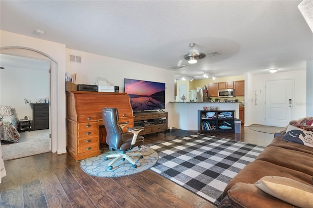 living room with dark hardwood / wood-style floors and a textured ceiling