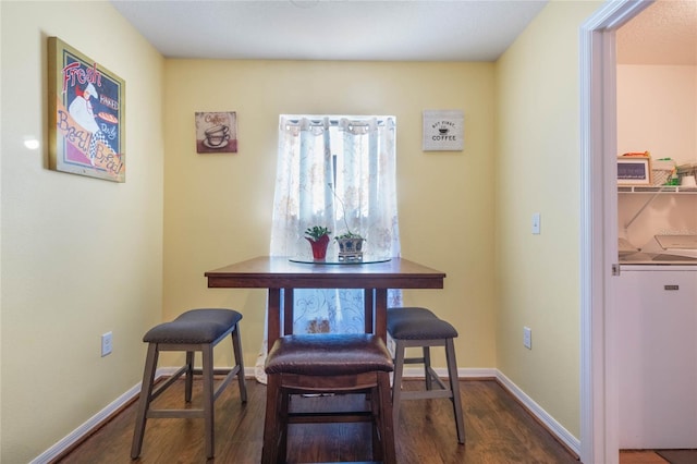 dining area with dark hardwood / wood-style flooring