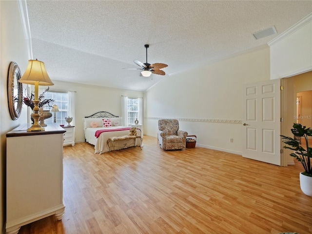 bedroom featuring multiple windows, vaulted ceiling, and light hardwood / wood-style flooring