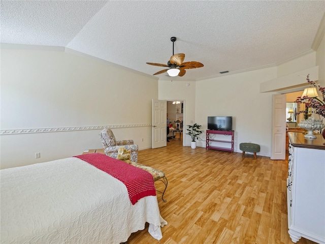 bedroom featuring hardwood / wood-style flooring, ceiling fan, lofted ceiling, and a textured ceiling