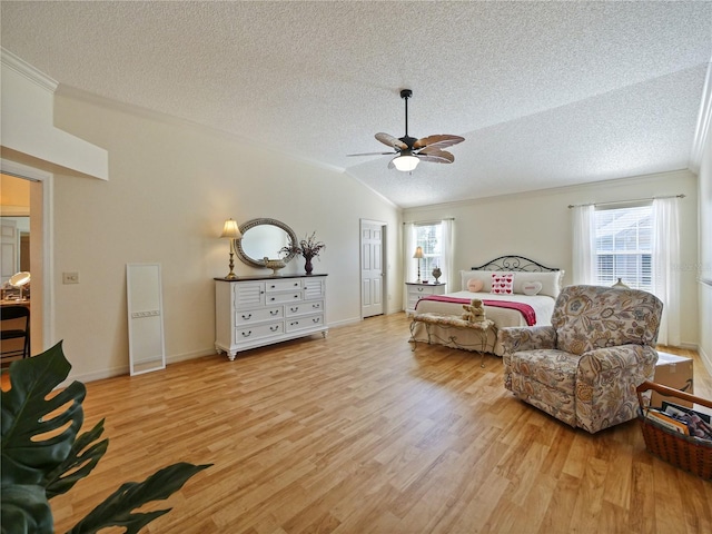bedroom featuring ornamental molding, lofted ceiling, light hardwood / wood-style flooring, and a textured ceiling