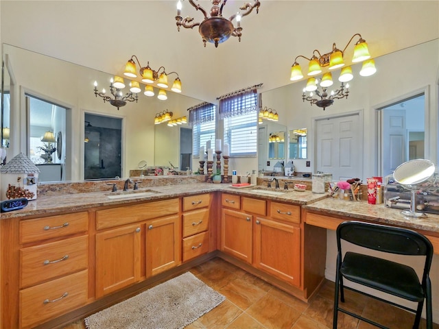 bathroom with vanity and a chandelier