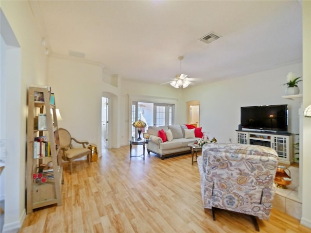 living room with ceiling fan and light wood-type flooring