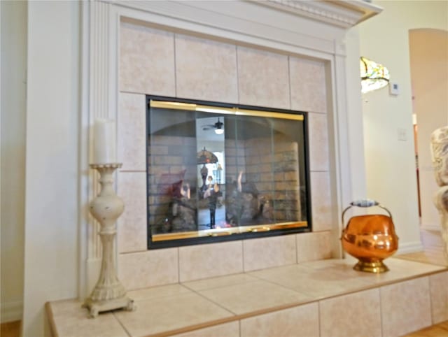 interior details with a tile fireplace