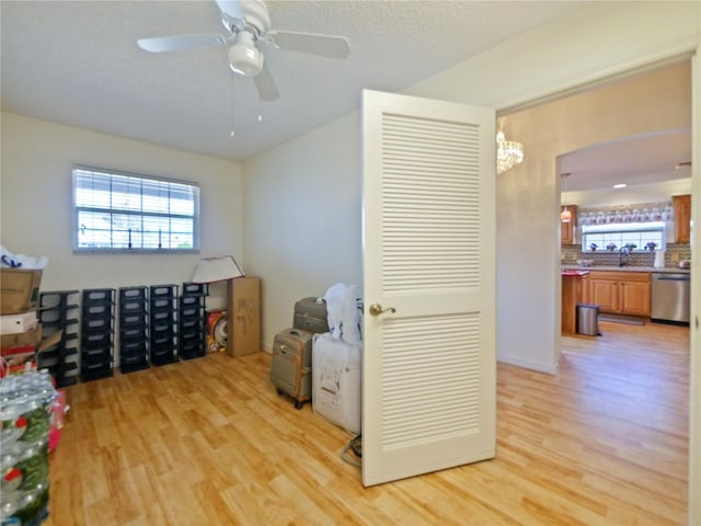 interior space featuring sink, a textured ceiling, light hardwood / wood-style flooring, and ceiling fan