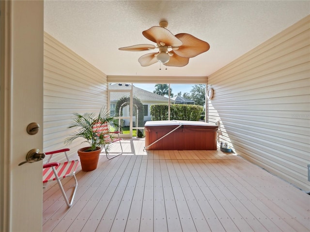 wooden terrace featuring a hot tub