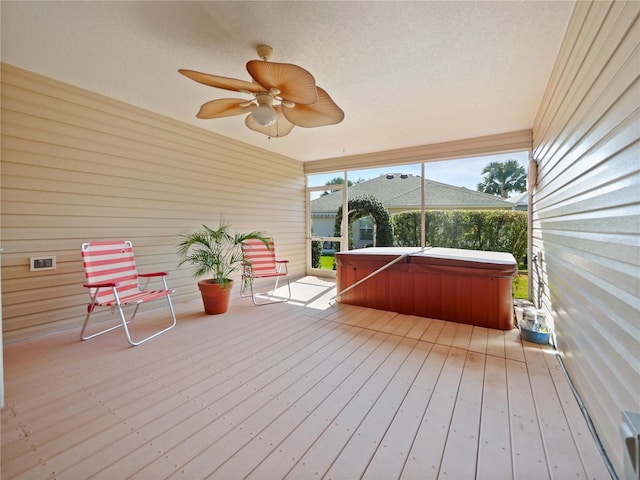wooden terrace with a hot tub and ceiling fan