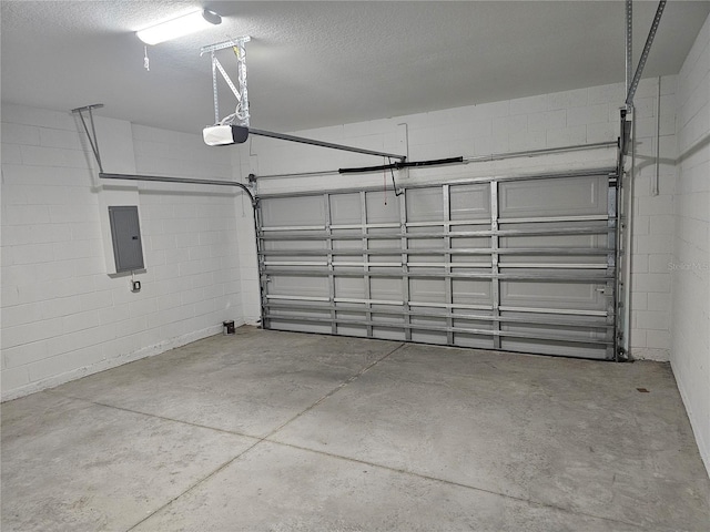 garage with electric panel and a garage door opener