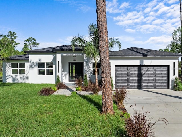 view of front of property with a garage and a front yard