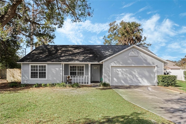 ranch-style home with a garage, a front yard, and covered porch