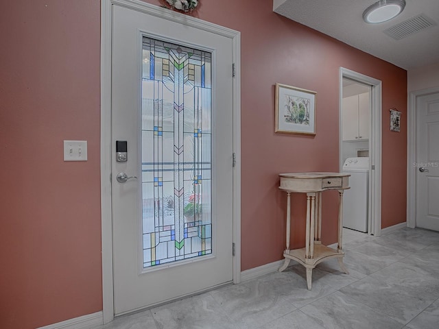 doorway to outside with washer / clothes dryer