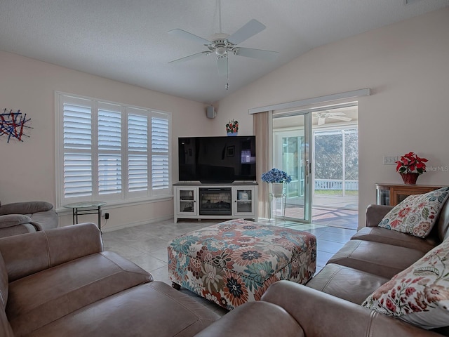 tiled living room featuring lofted ceiling, ceiling fan, and a textured ceiling