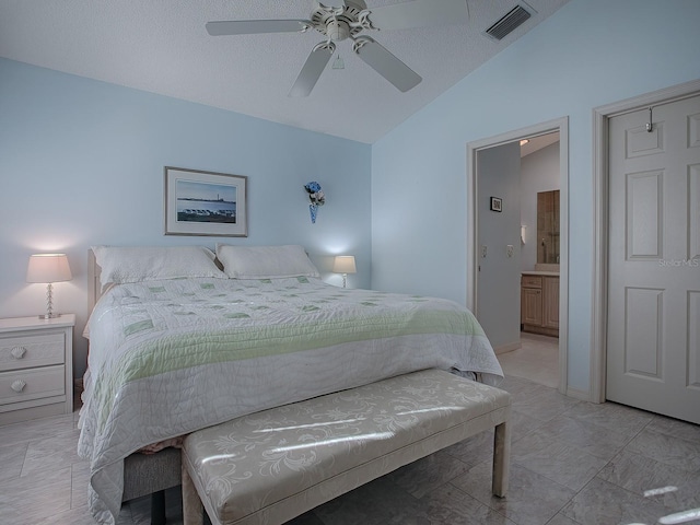 bedroom with ceiling fan, ensuite bathroom, and lofted ceiling