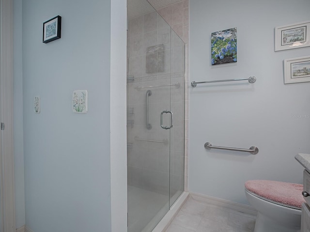 bathroom featuring toilet and a shower with door