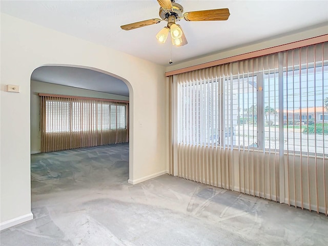 empty room with ceiling fan and carpet