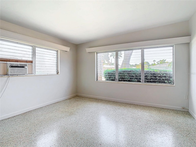 spare room with a healthy amount of sunlight and cooling unit