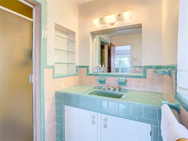 bathroom with vanity and a shower with shower door